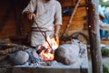 Fire crackling in blacksmith workshop of forging metal. Anonymouse craft smith create objects from wrought iron or steel