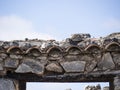 Fire damage on a terracotta tile roof. Burnt char and soot with a clear blue sky Royalty Free Stock Photo