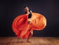 Fire dance. Female contemporary dancer in a dramatic pose against dark background.