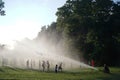 Fire department hose water cooling down the kids playing in the park in Kansas City, United States