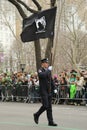 Fire Department of New York firefighter marching with MIA-FDNY flag at the St. Patrick's Day Parade