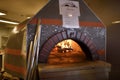 Fire in dome ceramic wood burning pizza oven in the kitchen of A Royalty Free Stock Photo