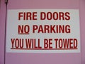 Fire doors no parking you will be towed sign Royalty Free Stock Photo