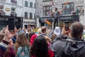 A fire eater street entertainer with a large crowd in Galway, Ireland being filmed by people with their phones