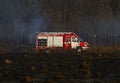 Fire engine. Black burnt earth. Conflagration. The fire that destroys forest Royalty Free Stock Photo