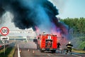 fire engine on the highway extinguishes a burning car after an accident Royalty Free Stock Photo