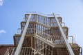 Fire escape. Building external steel staircase against a blue sky