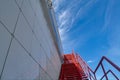 Fire escape on the facade of the building against a bright blue sky Royalty Free Stock Photo