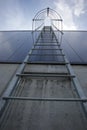 Fire escape on the industrial building above, bottom view. Stainless steel handrails, roof ladder. Detail view of stairs with Royalty Free Stock Photo