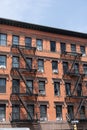 Fire escape ladder. Detail view of an old building with a brick wall and iron fire escape. Fire Escape stairs on the Royalty Free Stock Photo