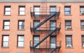 Fire escape ladders, brick building in New York.