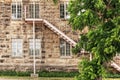 Fire escape stair case on side of stone building Royalty Free Stock Photo