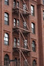 Fire escape stairs-downtown back alley architecture-steel and red brick background