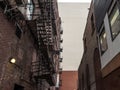 Fire escape stairs and ladder, in metal, on a typical North American old brick building from the Old Montreal, Quebec, Canada. Royalty Free Stock Photo