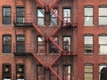 Fire Escape stairs on red brick classic building wall. Royalty Free Stock Photo