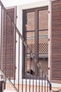 Fire Escape stairs beside window, brick wall in glass reflection. Architecture background Royalty Free Stock Photo