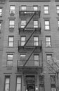 Fire escape stairway on exterior of red brick walkup apartment building Royalty Free Stock Photo