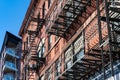 Fire Escapes on an Old Brick Building Next to a Modern Building in Long Island City Queens New York