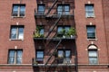Fire Escapes with Potted Plants on an Old Brick Apartment Building in Astoria Queens New York Royalty Free Stock Photo