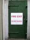 Fire exit do not block! sign on a green door Royalty Free Stock Photo