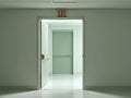 Fire exit door at the end of a corridor with clear signage and soft lighting for safety concept Royalty Free Stock Photo