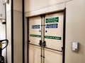 Fire exit doors with safety signage and push bars in an industrial facility Royalty Free Stock Photo