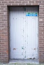 Fire exit keep clear sign on back entrance door at theatre