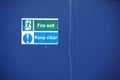 Fire exit keep clear sign on construction building site door Royalty Free Stock Photo