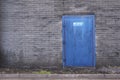 Fire exit keep clear sign on factory outside door blue red and shades of grey Royalty Free Stock Photo