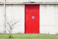 Fire exit red door and white wall at work place Royalty Free Stock Photo