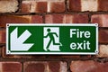 Fire exit sign on the red clay brick wall