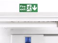 Fire Exit sign on the wall entry the room, green safety symbol icon isolated in the white door. Caution for warning in dangerous.