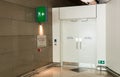 Fire exit way door and fire exit sign light-box in the airport terminal emergency exit way. Royalty Free Stock Photo