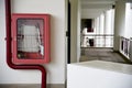 Fire extinguisher and fire hose reel in hotel corridor. Fire hoses rack for use. Royalty Free Stock Photo