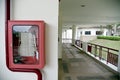 Fire extinguisher and fire hose reel in hotel corridor. Fire hoses rack for use. Royalty Free Stock Photo