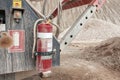 Fire extinguisher hanged on the quarry mining equipment