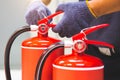 Fire extinguisher has hand engineer checking handle of fire extinguishers to prepare fire equipment for protection and prevent in Royalty Free Stock Photo