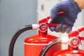 Fire extinguisher has hand engineer checking handle to prepare fire equipment for protection and prevent in emergency case and Royalty Free Stock Photo