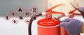 Fire extinguisher has hand engineer checking pressure gauges with exit door to prepare fire equipment for protection in emergency Royalty Free Stock Photo
