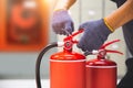 Fire extinguisher has hand engineer checking safety pin to prepare fire equipment for protection and prevent in emergency case and Royalty Free Stock Photo