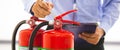 Fire extinguisher has hand engineer inspection checking pressure gauges to prepare fire equipment for protection and prevent in Royalty Free Stock Photo