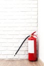 Fire extinguisher near white wall Royalty Free Stock Photo