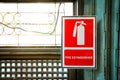 Fire extinguisher sign beside the window