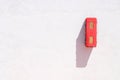 Fire extinguisher in the red box on the wall on the white background. Minimalistic wallpaper Royalty Free Stock Photo