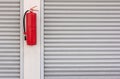 Fire extinguisher on the shutter door Royalty Free Stock Photo