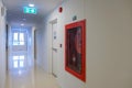 Fire extinguisher system on the wall with Fire Exit door sign for emergency. Stairwell fire for escape in building or apartment Royalty Free Stock Photo