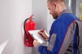 Fire Extinguisher Technician Ensuring Safety By Inspecting Royalty Free Stock Photo