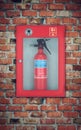 Fire extinguisher in wall box. brick wall Royalty Free Stock Photo