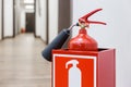 Fire extinguisher in white corridor of business center Royalty Free Stock Photo