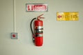 Fire extinguisher on the white wall. Royalty Free Stock Photo